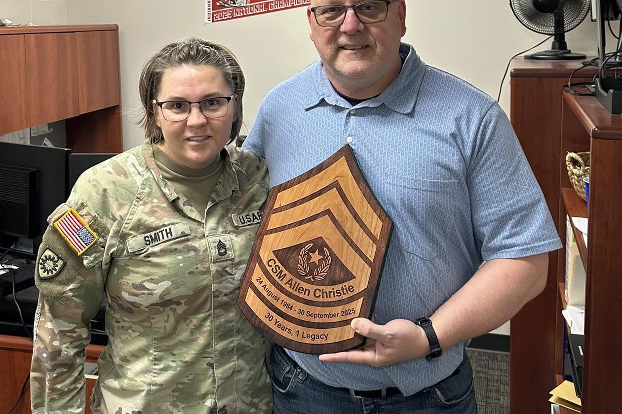 SFC Patricia D. Smith presenting a retirement plaque to Command Sergeant Major Allen Christie